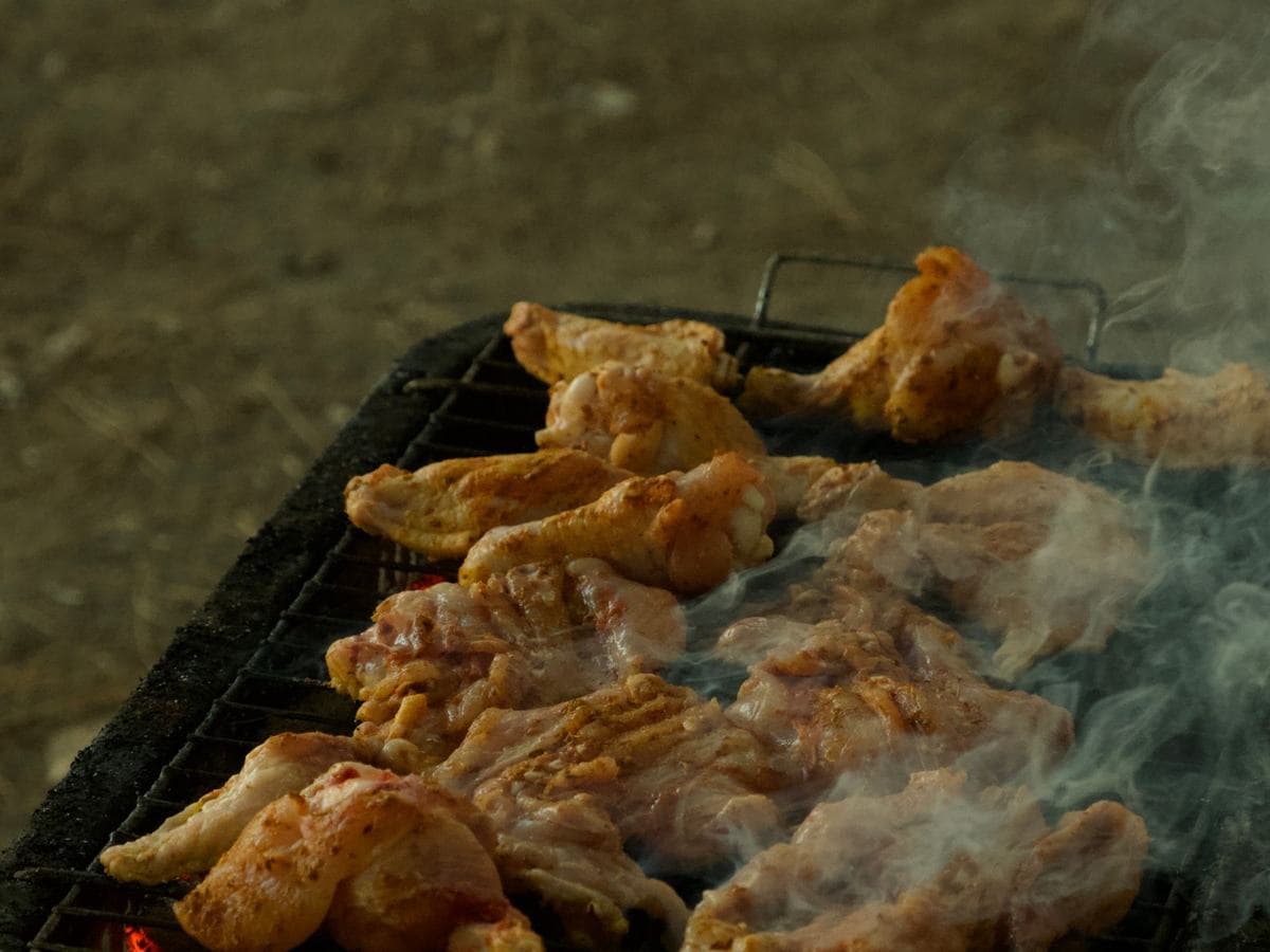 Chicken grilling over charcoal at Empire Food Point