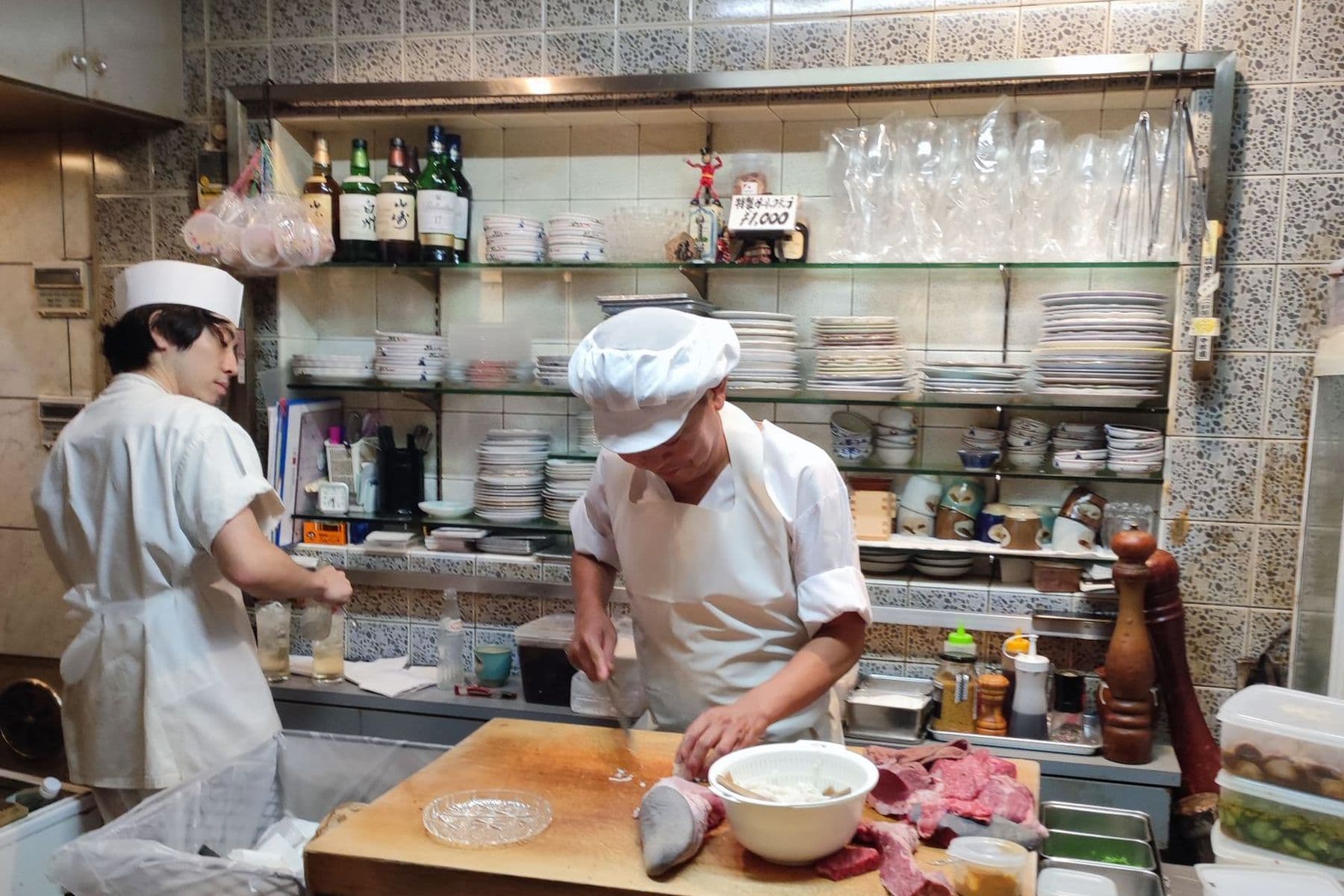 Chefs preparing orders in the Empire Food Point kitchen