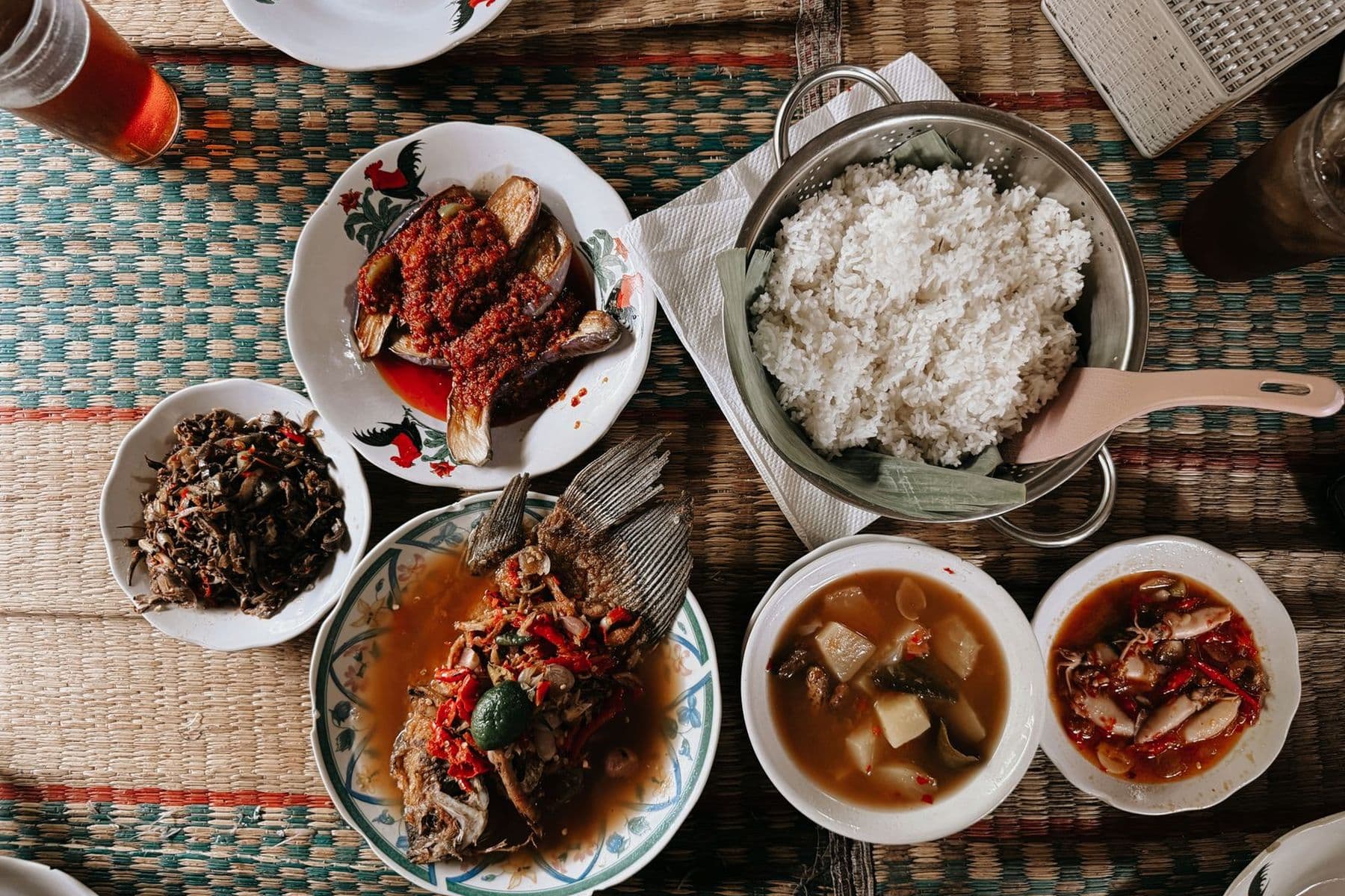 A table of freshly grilled dishes, rice and sides served at Empire Food Point